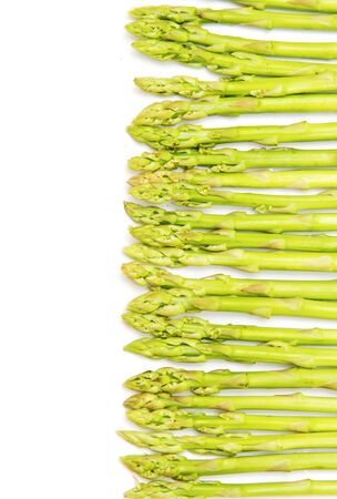 closed-up green asparagus on a white backgroundの写真素材