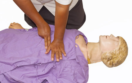 First aid instructor showing resuscitation technique using dummy on white background