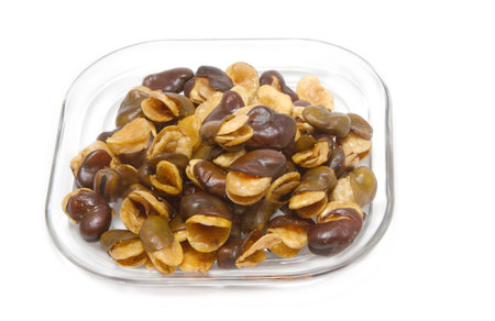 fava bean, roasted and salty on white background