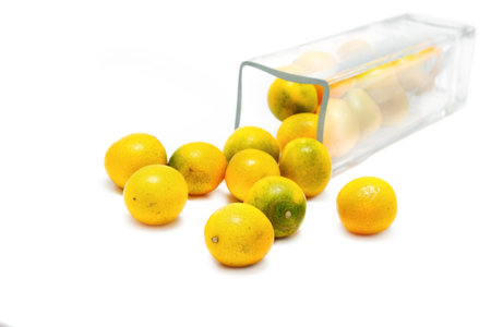 Kumquat Citrus in glass box on white background