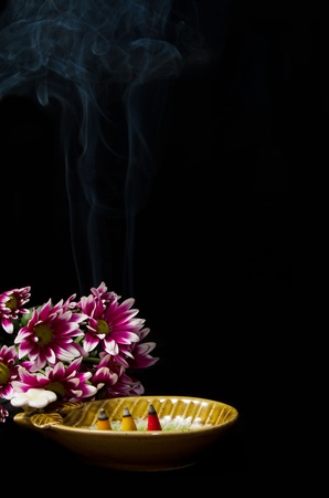 Spa incense  with  pink chrysanthemums on black  background の写真素材