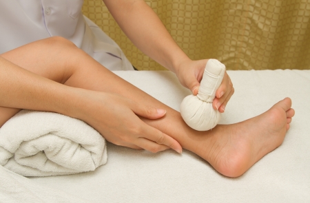 children massage with herbal compress ballsの写真素材