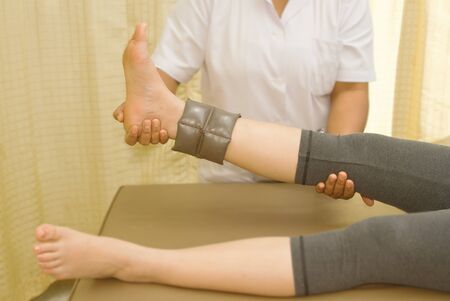 Rehab muscle training for leg with physical therapistの写真素材