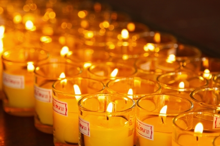 Burning candles at a Buddhist temple,Lighting of Praying candlesの写真素材