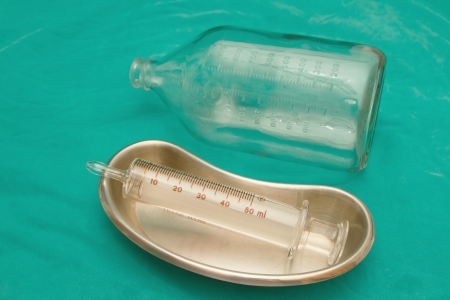Glass syringe in  sterile basin and glass bottle for tube feeding dietの写真素材