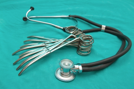 Stethoscope and surgery instrument set on green backgroundの写真素材