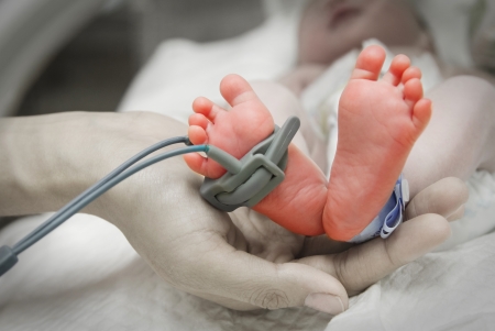   mother hand holding new born baby feet  sick の写真素材