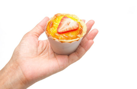 Hand with egg tart on isolate