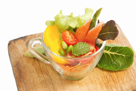fresh vegetable salad in transparent bowl on isolateの写真素材