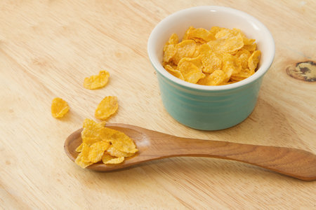 Corn flakes in wooden spoon