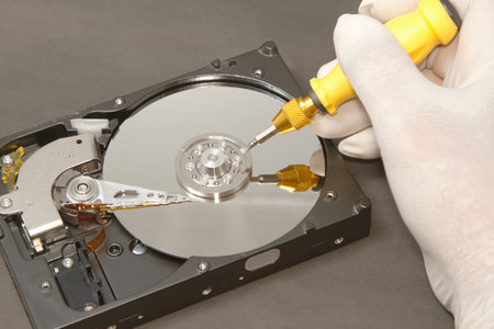  Hand with gloves repairs hard drive ,data recovery conceptの写真素材