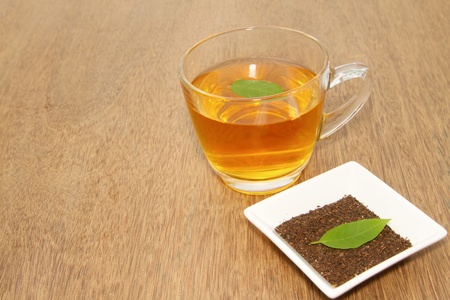 cup with tea and green leafの写真素材