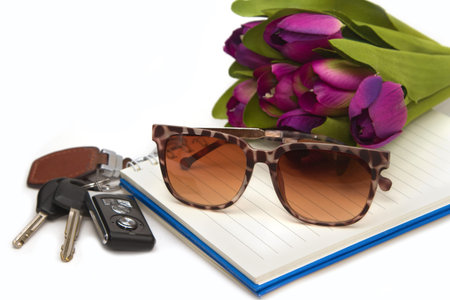 sunglasses and car key on book, concept travelling out doorの写真素材