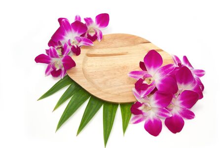 Empty wooden plate with orchid in tablewareの写真素材
