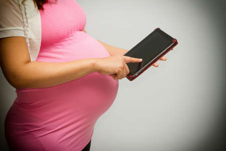 pregnant  woman using a tablet pc の写真素材