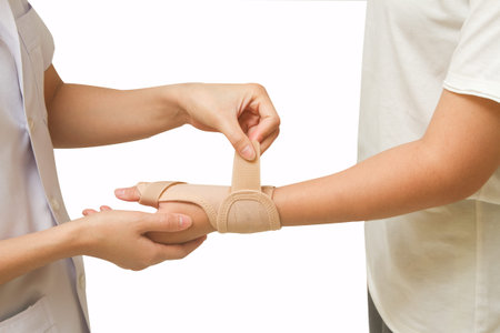 Physical therapist helps woman's patient wearing a wrist  brace