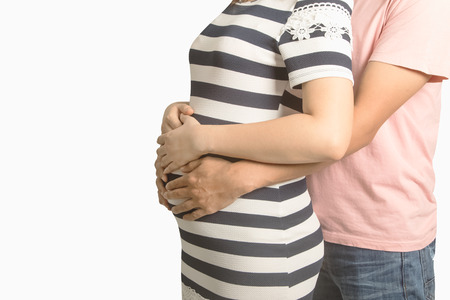 Pregnant couple. Husband touching his wife belly with handsの写真素材