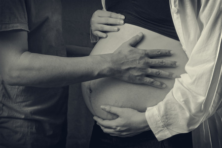 Pregnant woman and her husband isolatedの写真素材