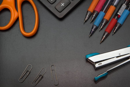 closeup office stationery on black background, back to shcool concept