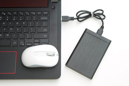 external hard disk connect to computer notebook on white.