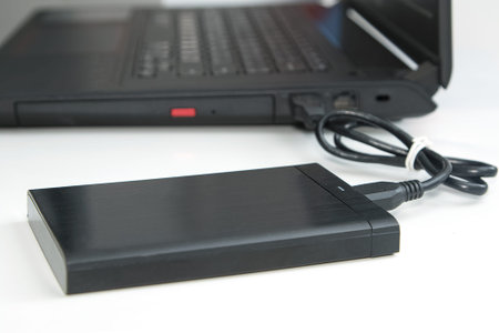 external hard disk connect to computer notebook on white.