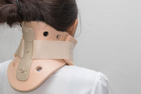 Woman with neck ache has a philadelphia collarの写真素材