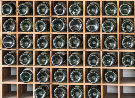 Old red wine bottles in the cellarの写真素材