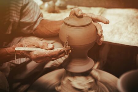 Potter makes on the pottery wheel clay pot.の写真素材