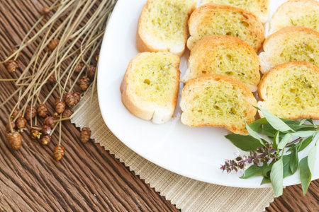Homemade garlic bread in the gardenの写真素材