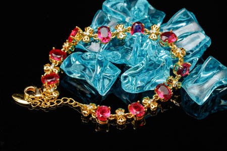 Ruby gold bracelet isolated on black backgroundの写真素材