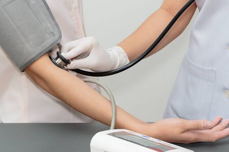 Doctor and patient. Measurement of blood pressure in a hospitalの写真素材