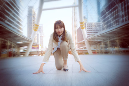 Businesswoman standing in start position runner,Business competition concept.