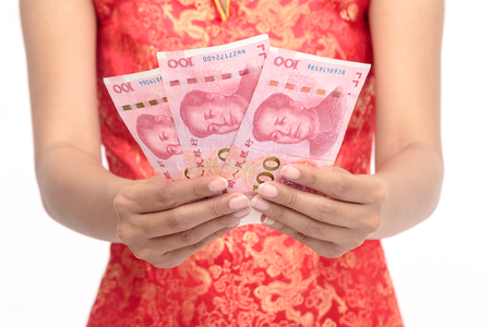 Chinese woman dress traditional cheongsam hold some of bank notes in handの写真素材