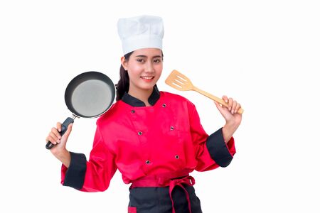 Smiling chef woman in red uniform holding cooking utensilsの写真素材