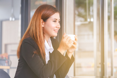 beautiful young business woman drinking coffee の写真素材