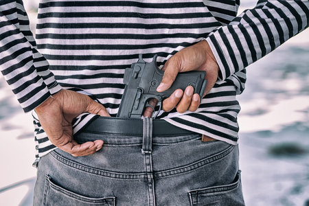 Closeup murder hidden gun behind his back