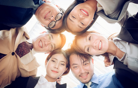 Happy success business team ,Businesspeople putting heads together の写真素材