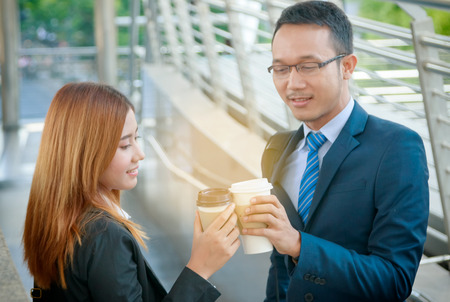 Young businesspeople colleague discussing. businessman and businesswomen drinking coffee outside the officeの写真素材