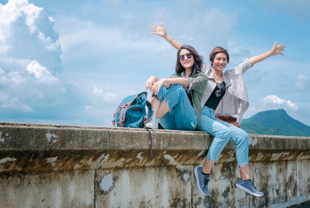Happy tourist Asian couple relaxing together on vacation trip.の写真素材