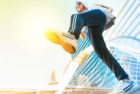 Man in sportswear jumping in front of urban buildings