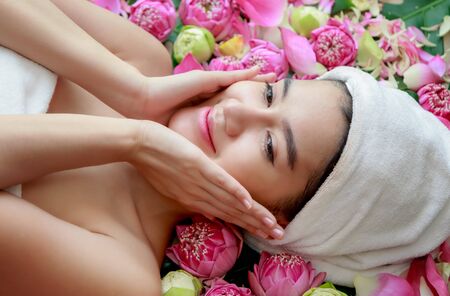Happy relax woman in spa salon lying on the massage deskの写真素材