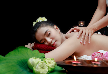 Young beautiful Asian woman having massage in spa environment.の写真素材