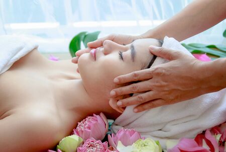 Happy relax woman getting facial massage at beauty salon.の写真素材