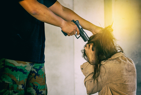 Woman kidnapped by criminals who threatening her by gun.の写真素材