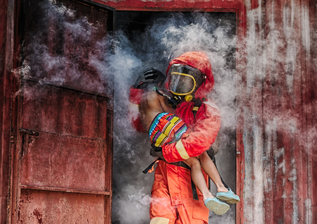 Emergency Fire Rescue training,Firefighters save the boy from burnt placeの写真素材