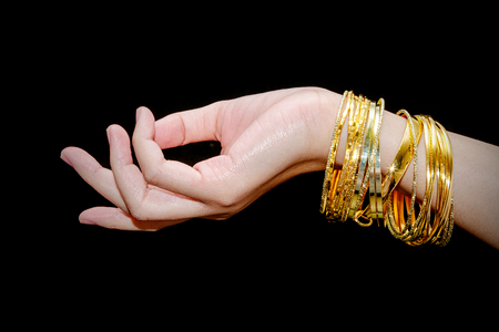 Beautiful woman hand hold gold bracelet jewelry, accessory and fashion.の写真素材