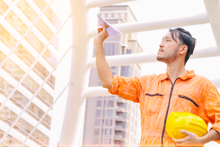 businessman pointing up and looking up to future standing in modern city,teamwork  conceptの写真素材