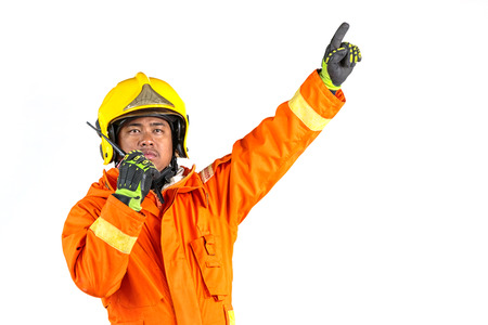 Firefighter in uniform and safety helmet standing full body length の写真素材