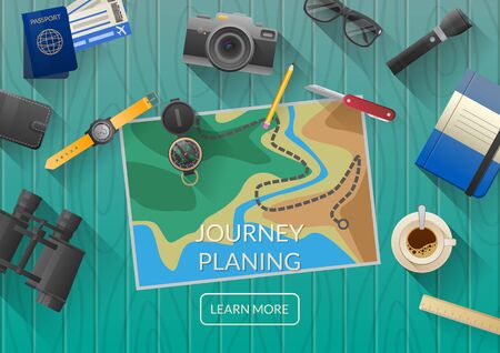Man planning vacation trip with map. Top view. Outfit of modern traveler. Objects on wooden background.の写真素材