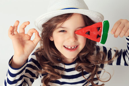 Girl with a lollipop watermelon shaped